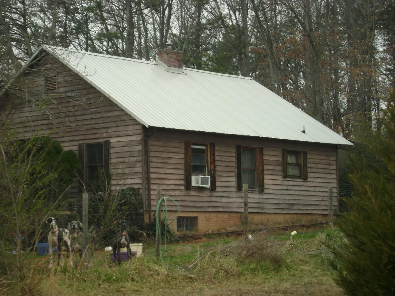 White metal roof on an old wood sided farmhouse, from a Metal Roof Installation job in Danville